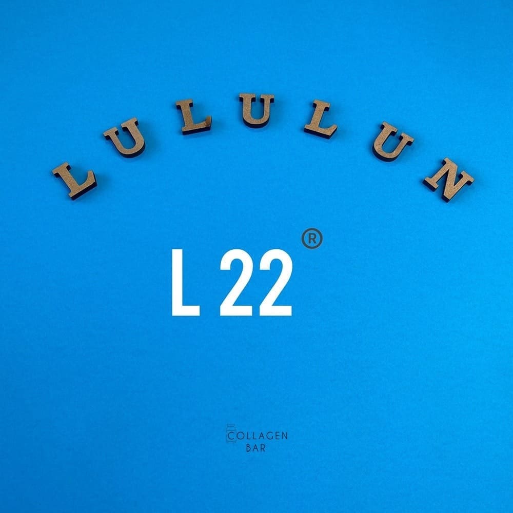 Слово LuLuLun, выложенное деревянными буквами и изображение символа L 22 на синем фоне