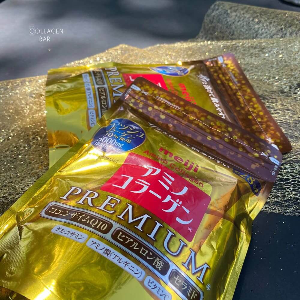 Две упаковки коллагена Meiji Amino Premium NEW на золотисто-черном фоне