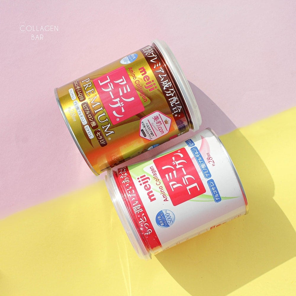 Колаген Meiji Amino Premiun і Meiji Amino Collagen у банках поруч на жовто-рожевому тлі.
