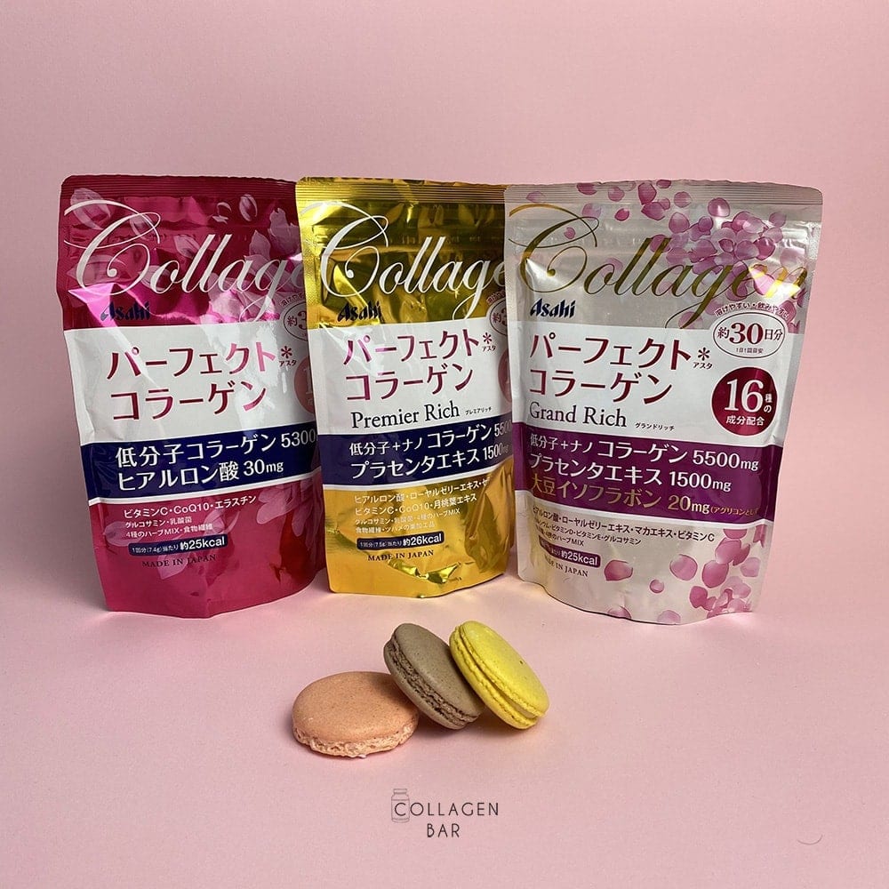 Колагени Asahi Perfect Asta Collagen, Asahi Premier Rich і Asahi Grand Rich з різнокольоровими макаронами на рожевому тлі