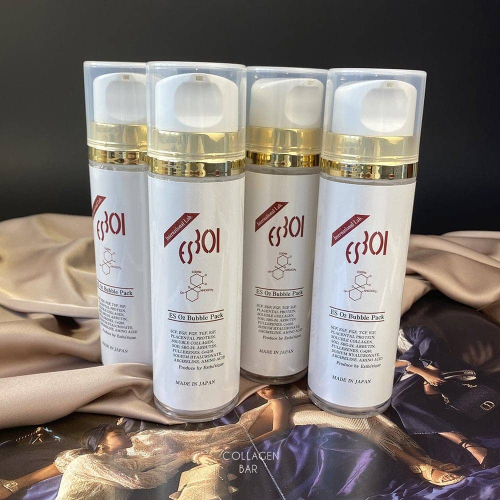 Четыре вертикально стоящих флакона карбокси маски ES 301 ES O2 Bubble Pack со светло-коричневой тканью