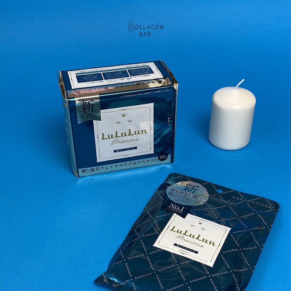 Маска LuLuLun Precious Green в упаковках на 32 і 7 штук на синьому тлі з білою свічкою