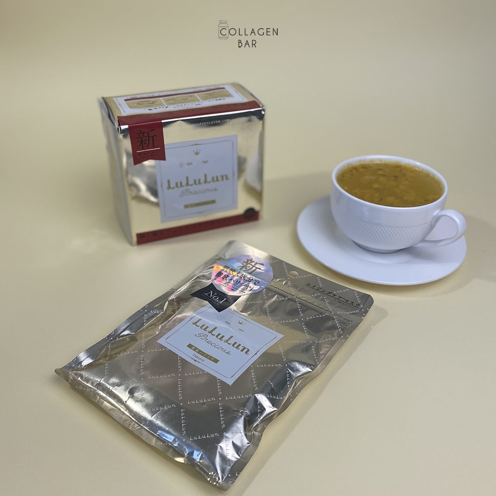 Дві упаковки масок LuLuLun Precious White на 32 і 7 штук з чашкою обліпихового чаю на білому блюдці