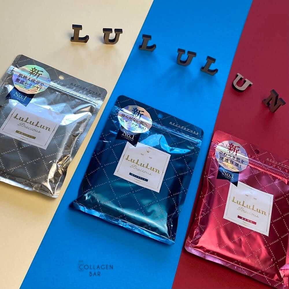 Маски LuLuLun Precious White, Green і Red в упаковках по 7 штук на смугастому тлі, над якими викладено слово LULULUN дерев'яними літерами