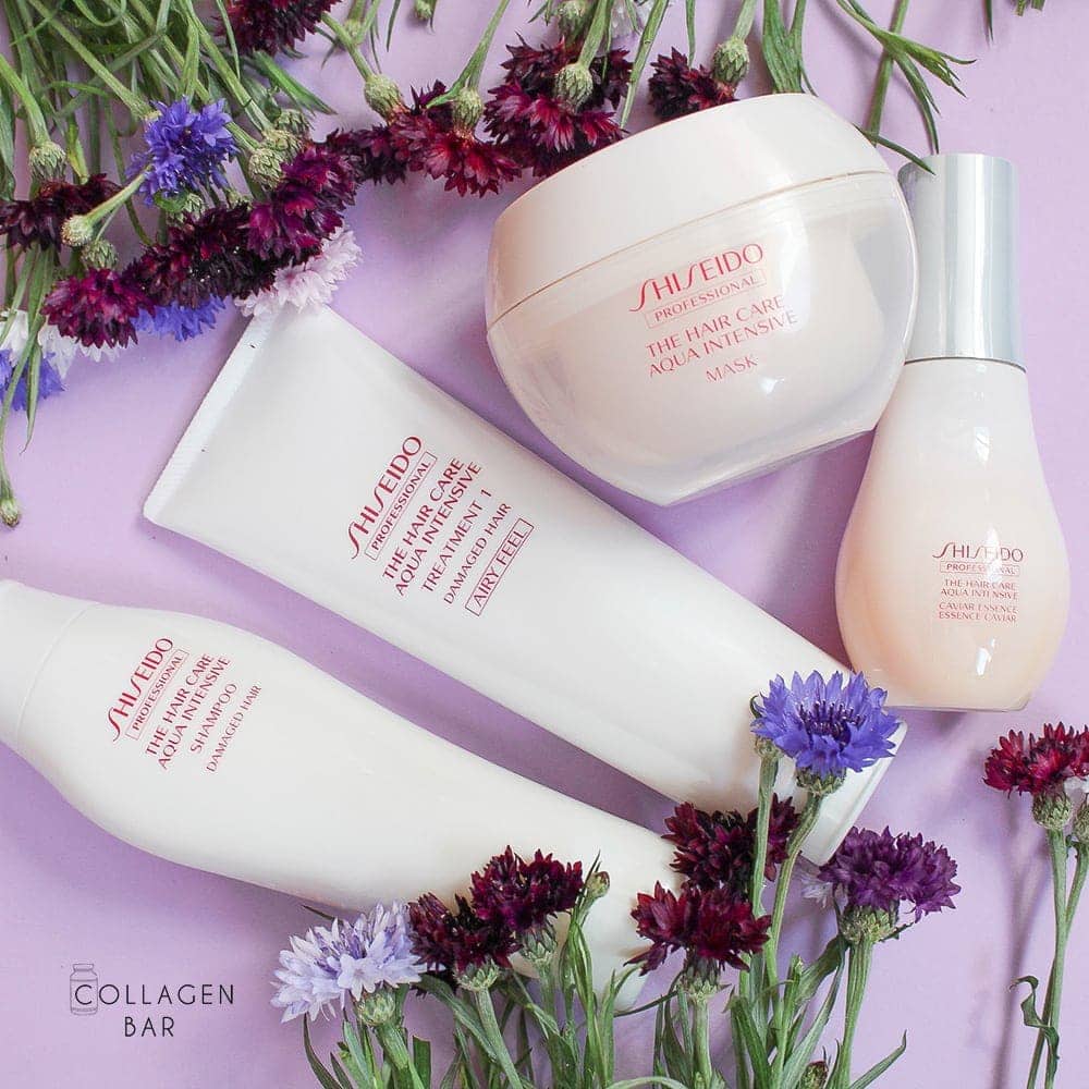 Система лікування волосся Shiseido Aqua Intensive (шампунь, кондиціонер, маска і сироватка) на фіолетовому тлі з квітами
