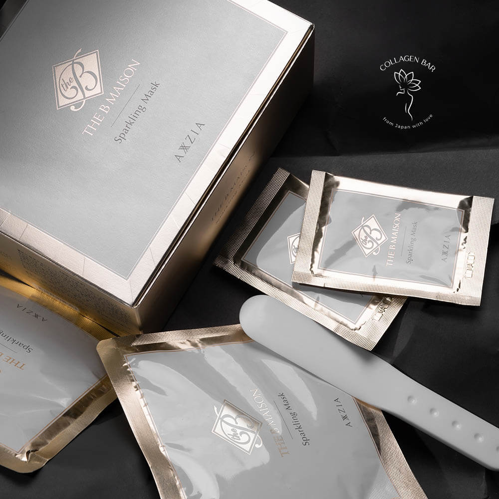 Дві фази карбоксі масок AXXZIA The B Maison Sparkling Mask у пакетиках поруч з коробкою зі спатулою