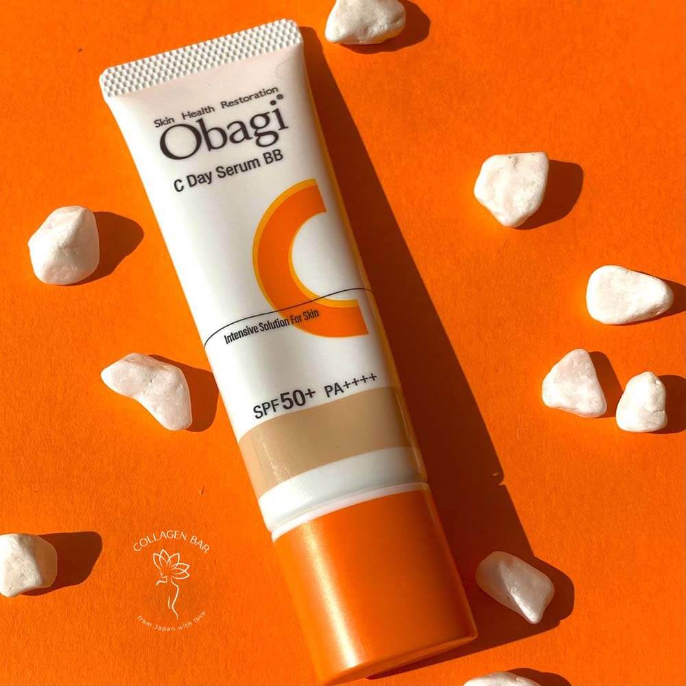 OBAGI C Day Serum SPF на яскраво-помаранчевому тлі в горизонтальному положенні з дрібними білими камінчиками