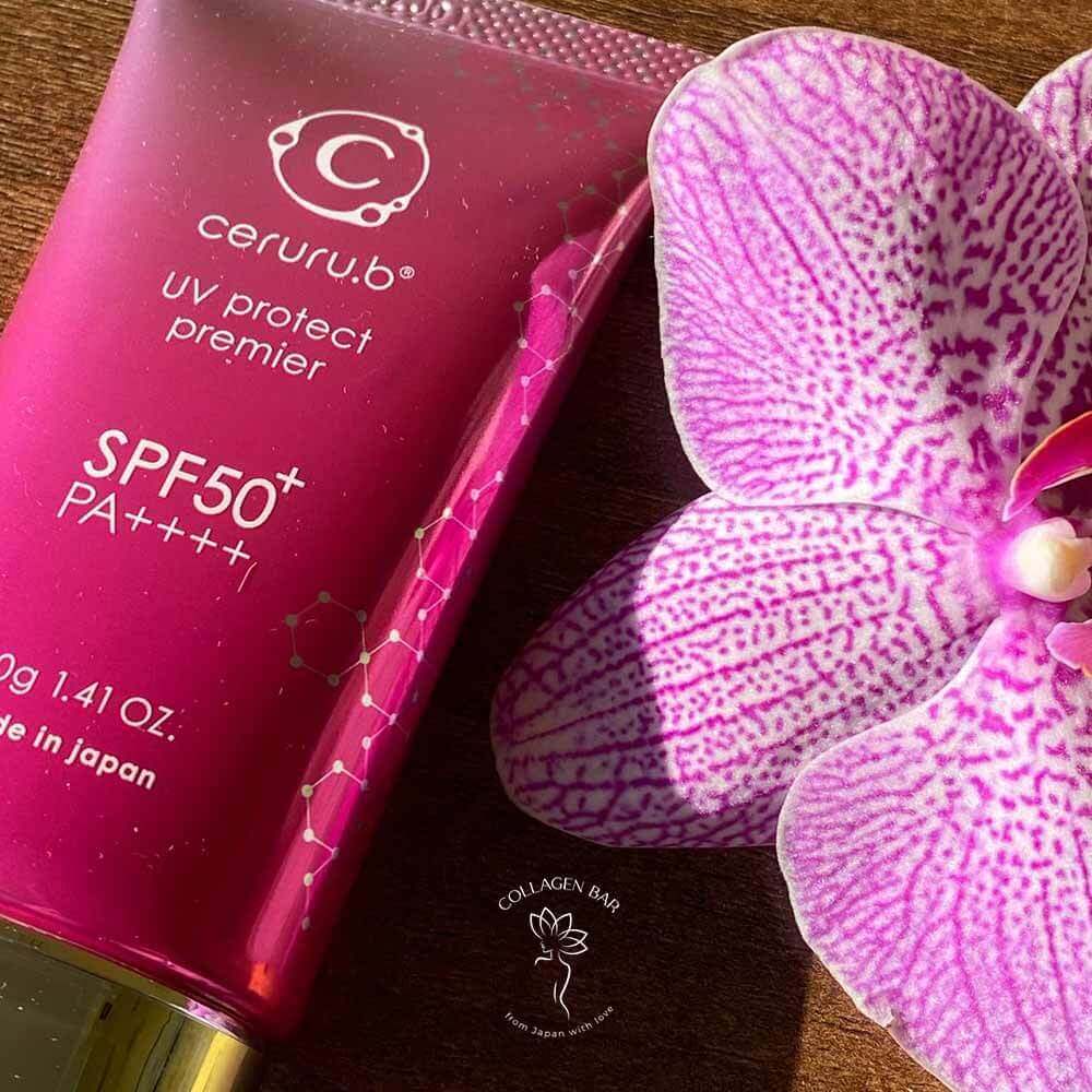 Санскрин ceruru.b UV Protect Premier і квітка плямистої фіолетової орхідеї поруч